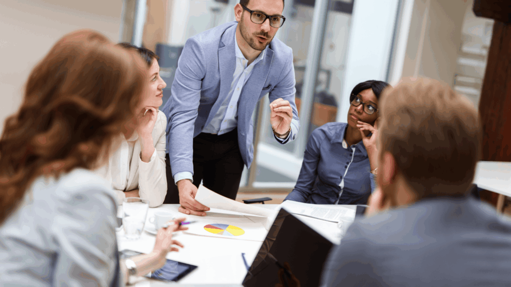 group of employees at a table discussing ideas