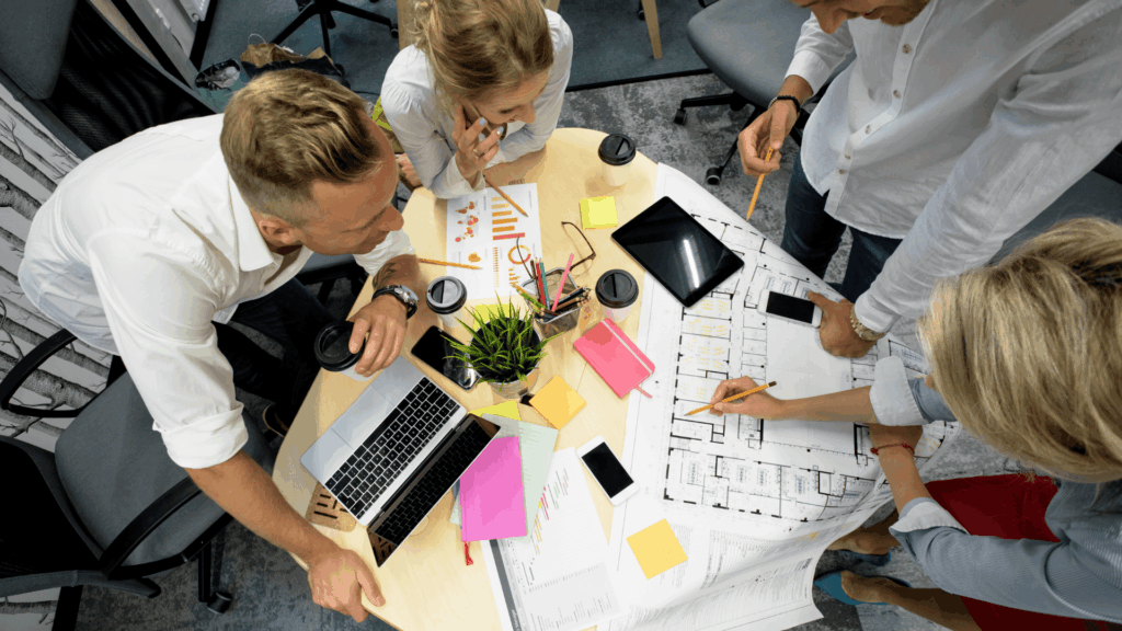 agile team working on a project with sticky notes over the table