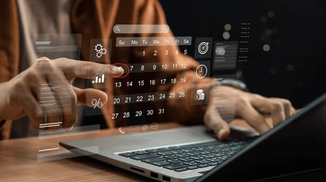 holographic calendar and person delivering projects with this calendar in front of a laptop